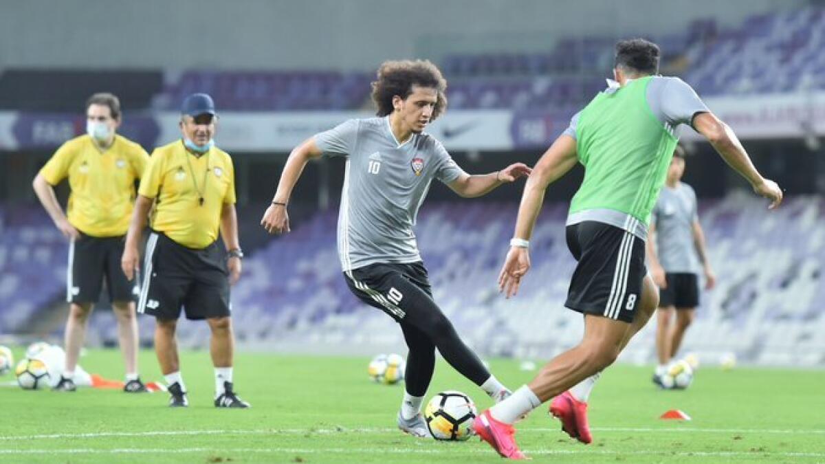 UAE midfielder Omar Abdulrahman makes a move as Jorge Luis Pinto watches from the background. - (UAEFA Twitter)