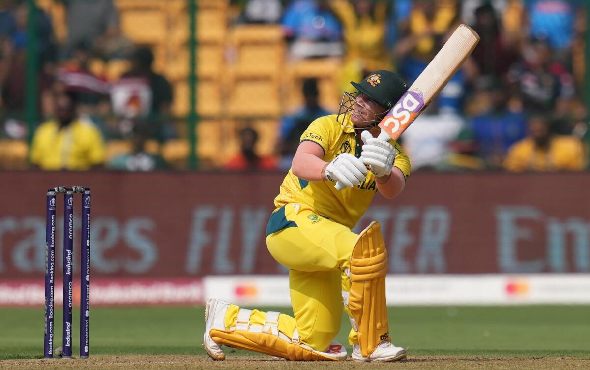 Australia’s David Warner plays a shot during the ICC Men's Cricket World Cup 2023 match between Pakistan and Australia at M. Chinnaswamy Stadium, in Bengaluru. - PTI