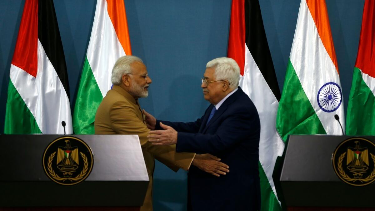 Palestinian president Mahmud Abbas (R) and Indian Prime Minister Narendra Modi embrace after their joint press conference.- AFP