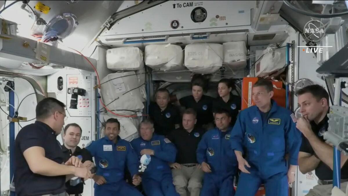 In this image from NASA TV, the four astronauts including UAE Sultan ALNeyadi, third left gather, during the welcoming ceremony, on the International Space Station, Friday. NASA TV via AP