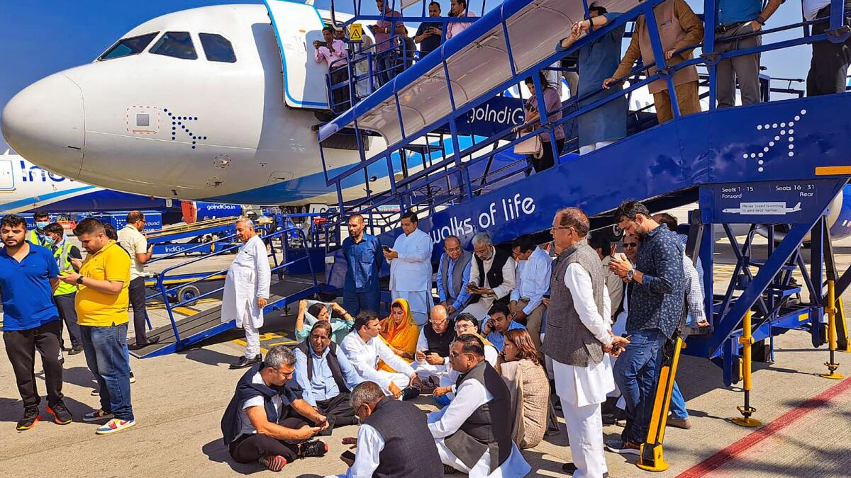 Congress leaders stage a sit-in protest at the IGI Airport after the party leader Pawan Khera was allegedly deboarded from the plane owing to an FIR against him in New Delhi onThursday. — PTI
