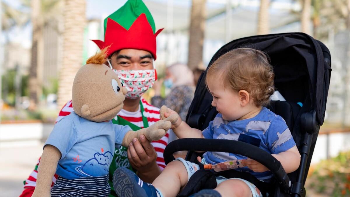 Santa’s helper with a child at the Mobility District, Expo 2020 Dubai. (Photo by Charbel Chalouhy/Expo 2020 Dubai)