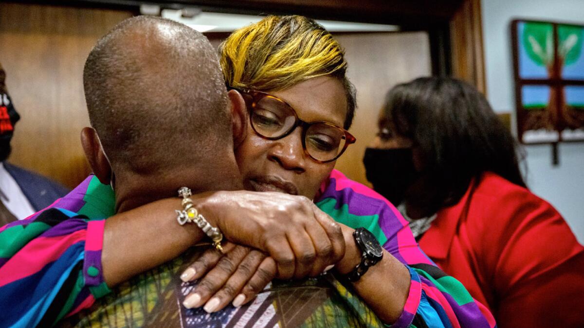 Ahmaud Arbery's mother Wanda Cooper-Jones is hugged by a supporter after the jury convicted Travis McMichael in November. — AP file