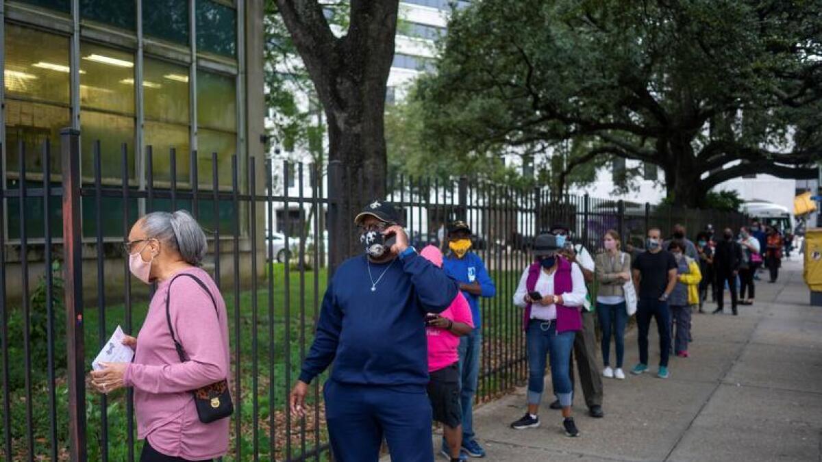 People line up to cast their ballot for the upcoming presidential election as early voting begins in New Orleans, Louisiana