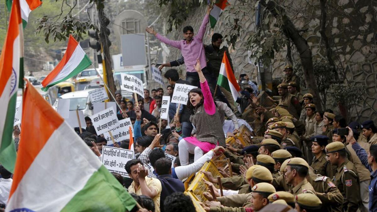 Police stop demonstrators during a protest against the students of Jawaharlal Nehru University (JNU) outside the university campus in New Delhi, India. 
