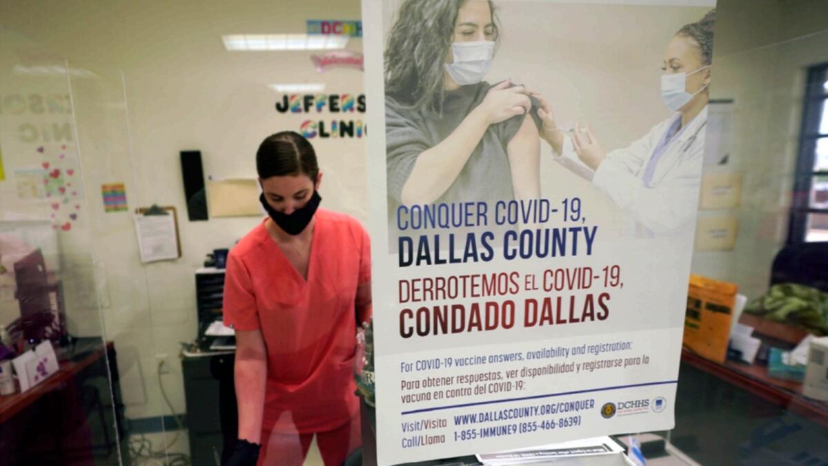 A Dallas County Health and Human Services nurse completes paperwork after administering a Covid-19 vaccine at a vaccination site in Dallas. — AP file