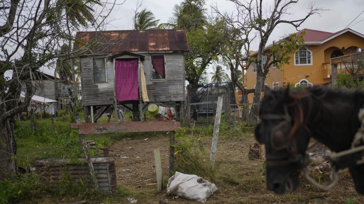 A wooden home stands on stilts in Ann's Grove, one of Guyana’s poorest communities. The nation's oil boom will generate billions of dollars for this largely impoverished nation. — AP