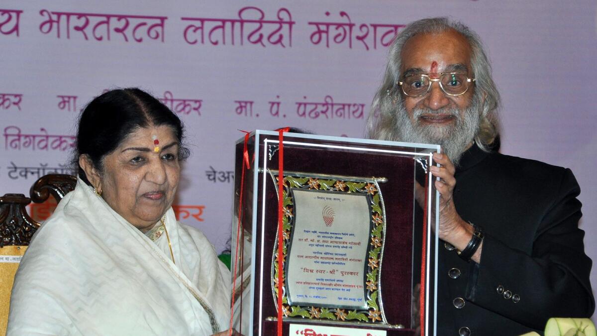 Lata Mangeshkar receives from Indian historian Shivshahir Babasaheb Purandare the 'Shree-Vidya Saraswati Puraskar' award during the Divine Felicitations ceremony in Mumbai in 2010. AFP file