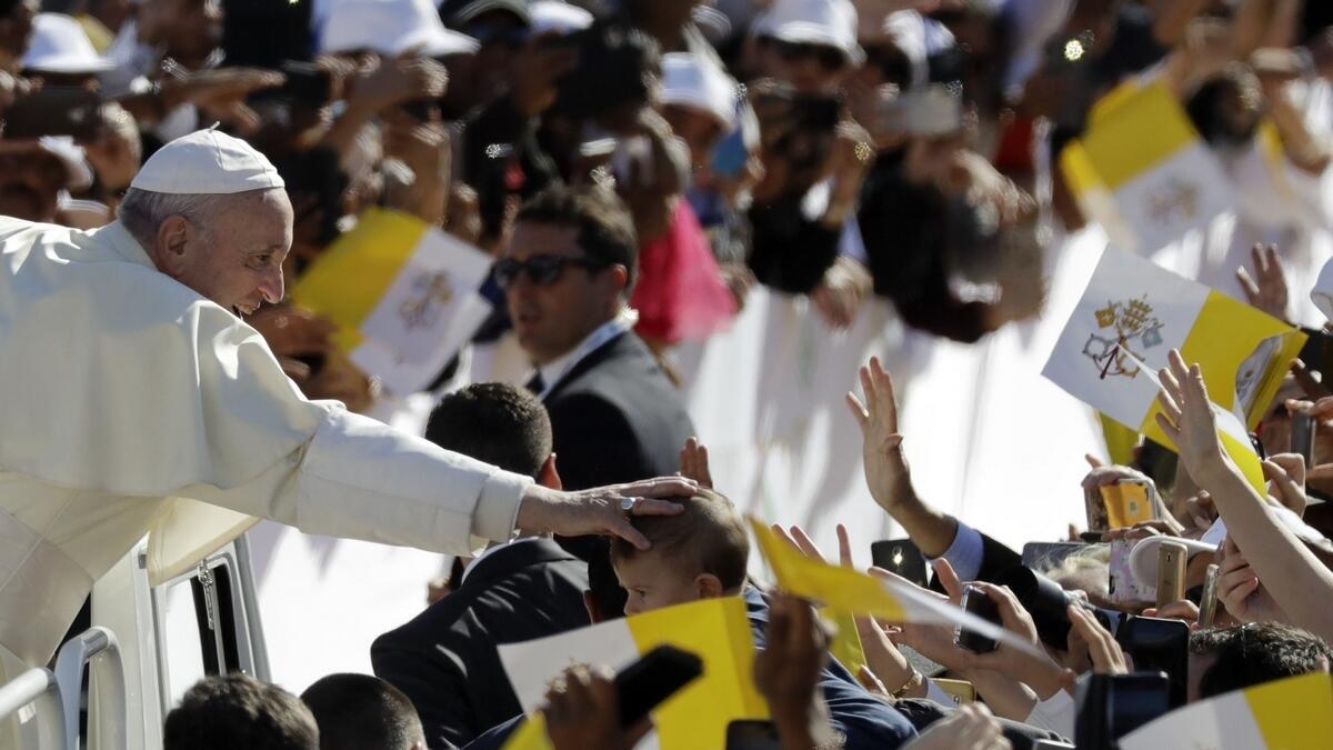 Pope Francis blesses a child at Zayed Sports City Stadium in Abu Dhabi.- AP