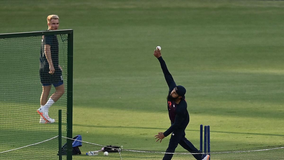 England's Adil Rashid (right) delivers a ball during a training session. — AFP