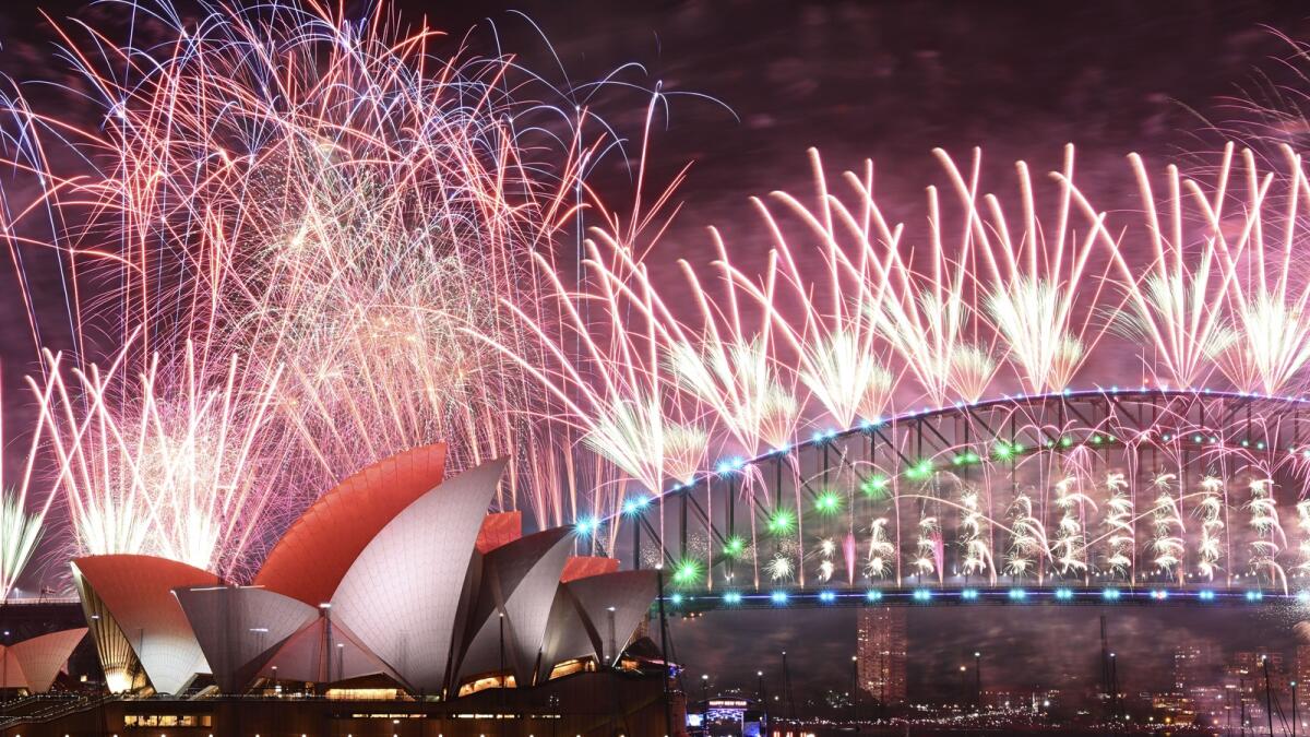 Fireworks explode over the Sydney Opera House and on the Harbour Bridge as part if New Year's Eve celebrations in Sydney,. — AP