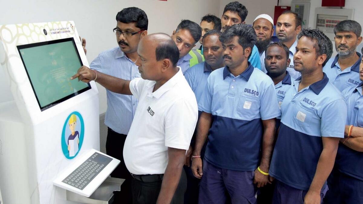 Workers check out a smart kiosk installed at Dulsco Village labour accommodation in Dubai. The kiosk gives out information in Arabic, English, Urdu and Malayalam. 