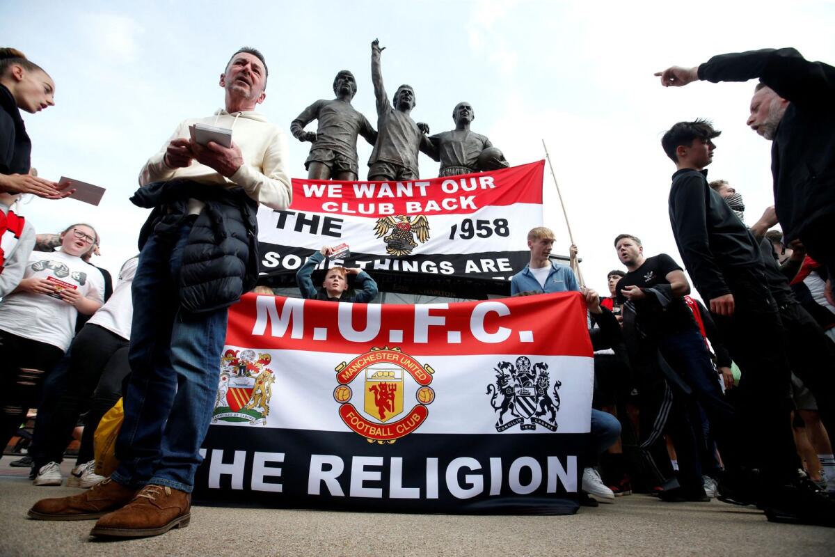FILE. Manchester United fans display banners in protest of the Glazer family’s ownership of the club. Photo: Reuters