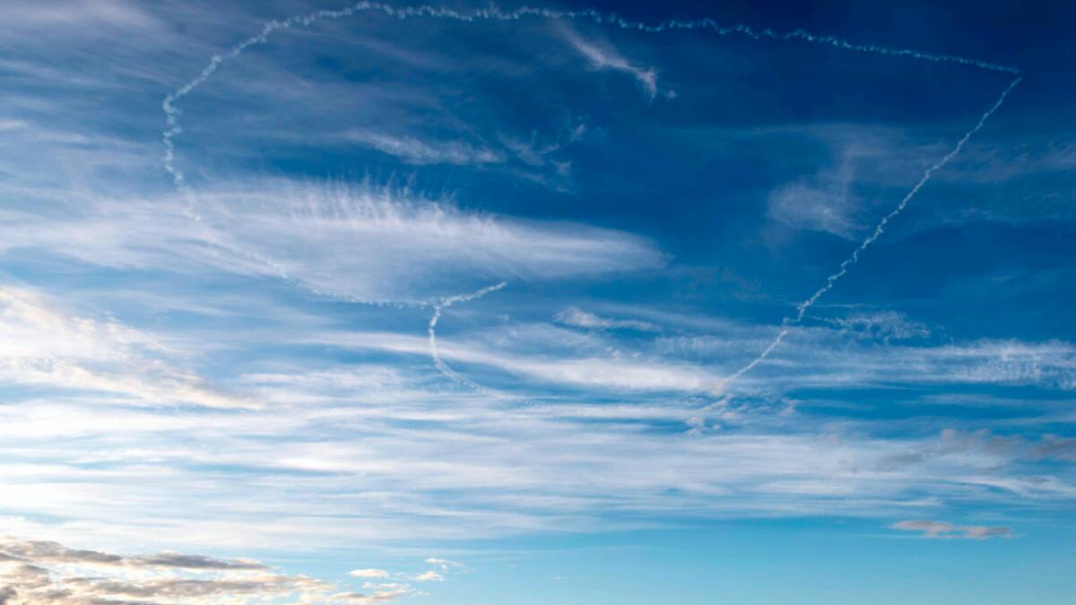 Two pilots from Scandinavian Airshow form a heart in the sky over Stockholm as a message for people affected by the coronavirus pandemic in Sweden. Photo: AFP