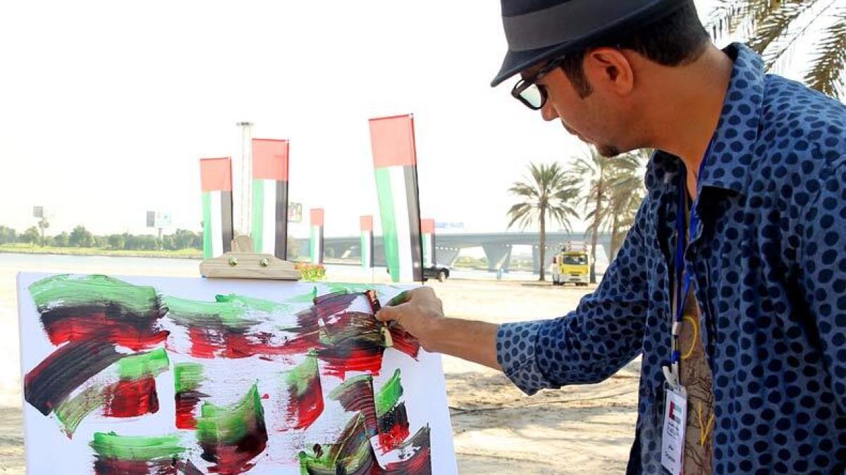 Visitors paint during the Flag Day celebrations at Dubai Creek Park. Photo by Juidin Bernarrd/ Khaleej Times