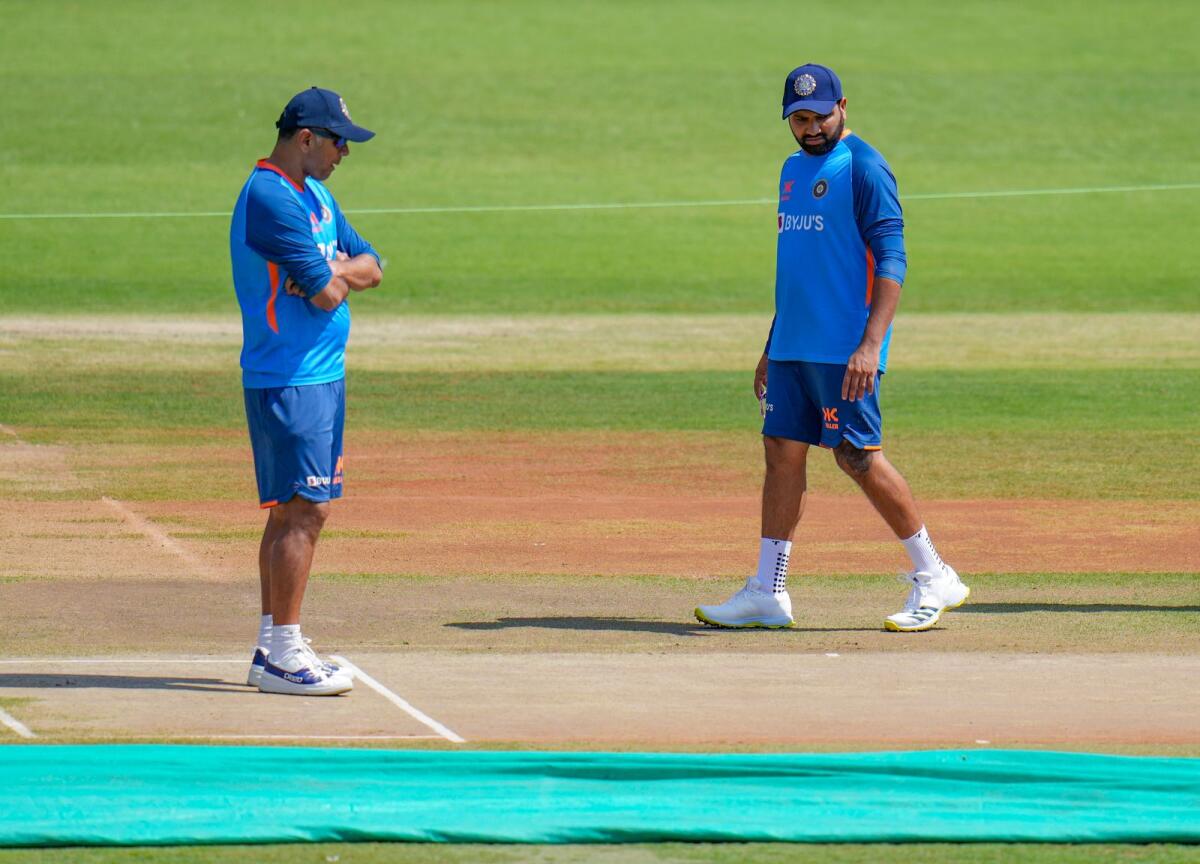 Indian coach Rahul Dravid (left) and captain Rohit Sharma inspect the pitch ahead of the third Test. — PTI