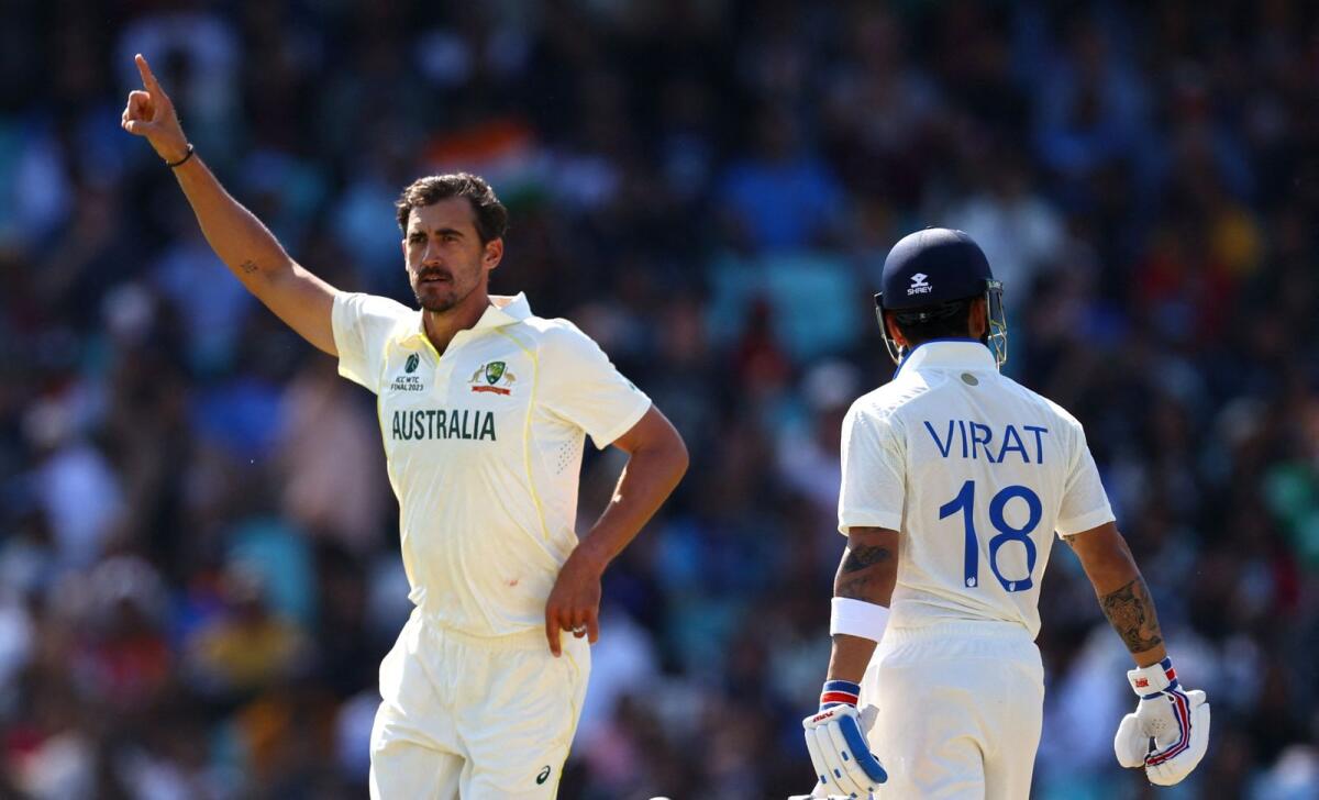 Australia's Mitchell Starc celebrates after taking the wicket of India's Virat Kohli. — Reuters