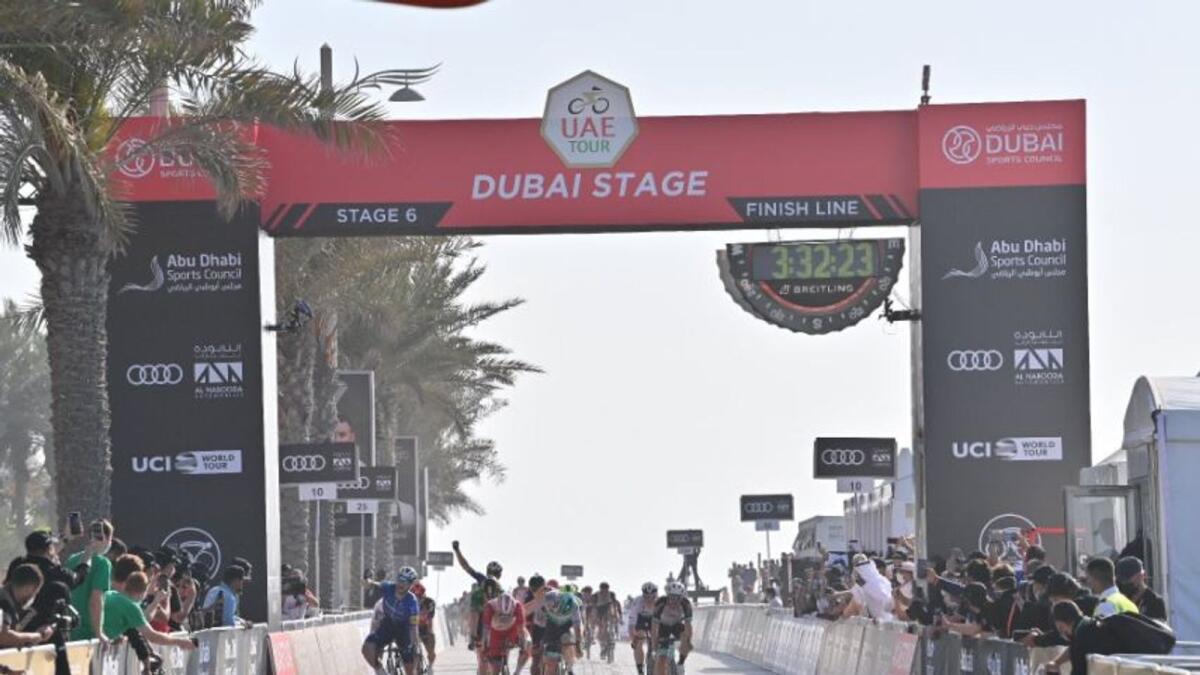 Riders cross the finish line at the Palm Jumeirah. (UAE Tour Twitter)