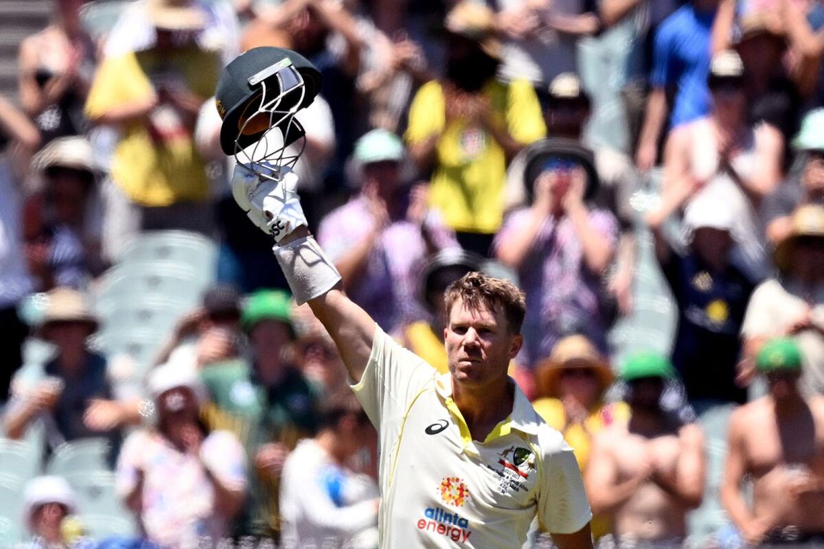 Australian batsman David Warner celebrates scoring his century. -- AFP