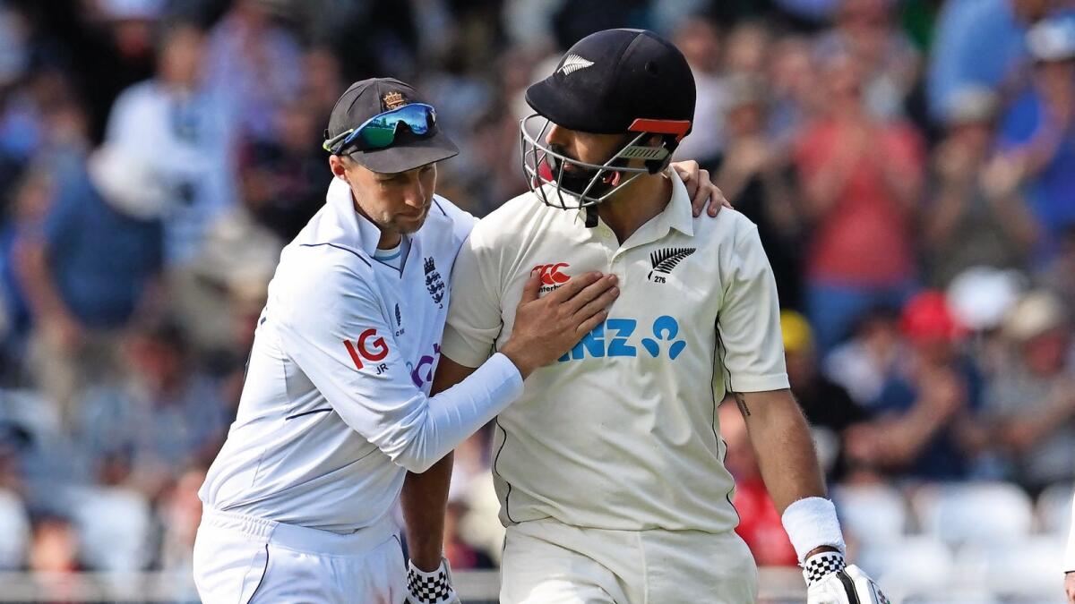 England's Joe Root (left) congratulates New Zealand's Daryl Mitchell as the latter walks back to the pavilion. — AFP