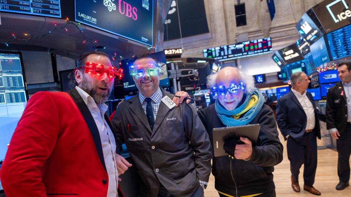 Traders work on the floor of the New York Stock Exchange on the last day of trading for the year on  Friday. The S&amp;P 500 ended the year on Friday with an annual gain of just over 24 per cent. — AFP