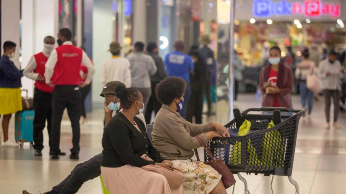 People shop in a mall in Johannesburg. — AP file