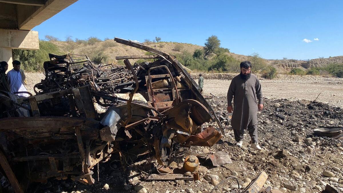 Residents look at the wreckage of a burnt passenger bus at Bela in Lasbela district of Balochistan province on January 29, 2023. — Photo used for illustrative purpose only. — AFP file