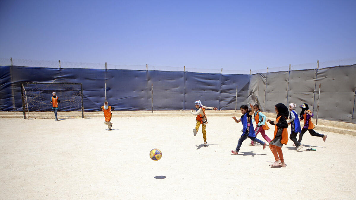 Syrian refugee girls play football at Zaatari refugee camp, in Mafraq, Jordan.