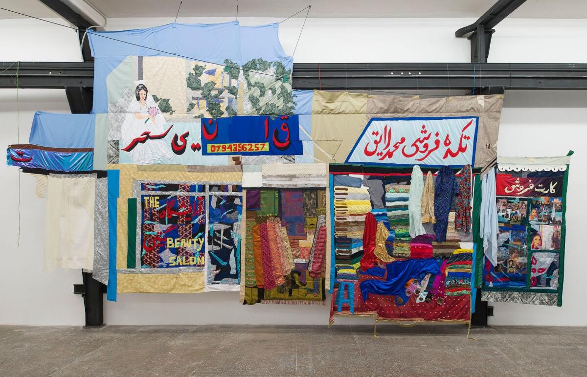 Hangama Amiri, Bazaar, 2020. Cotton, chiffon, muslin, silk, suede, digitally woven textile, camouflage fabric, sari textile, inkjet prints on paper and canvas, paper, plastic, acrylic paint, marker, polyester, table cloth, faux leather, and found fabric; 426.72 × 792.48 cm. Co urtesy of the artist and T293 Gallery, Rome