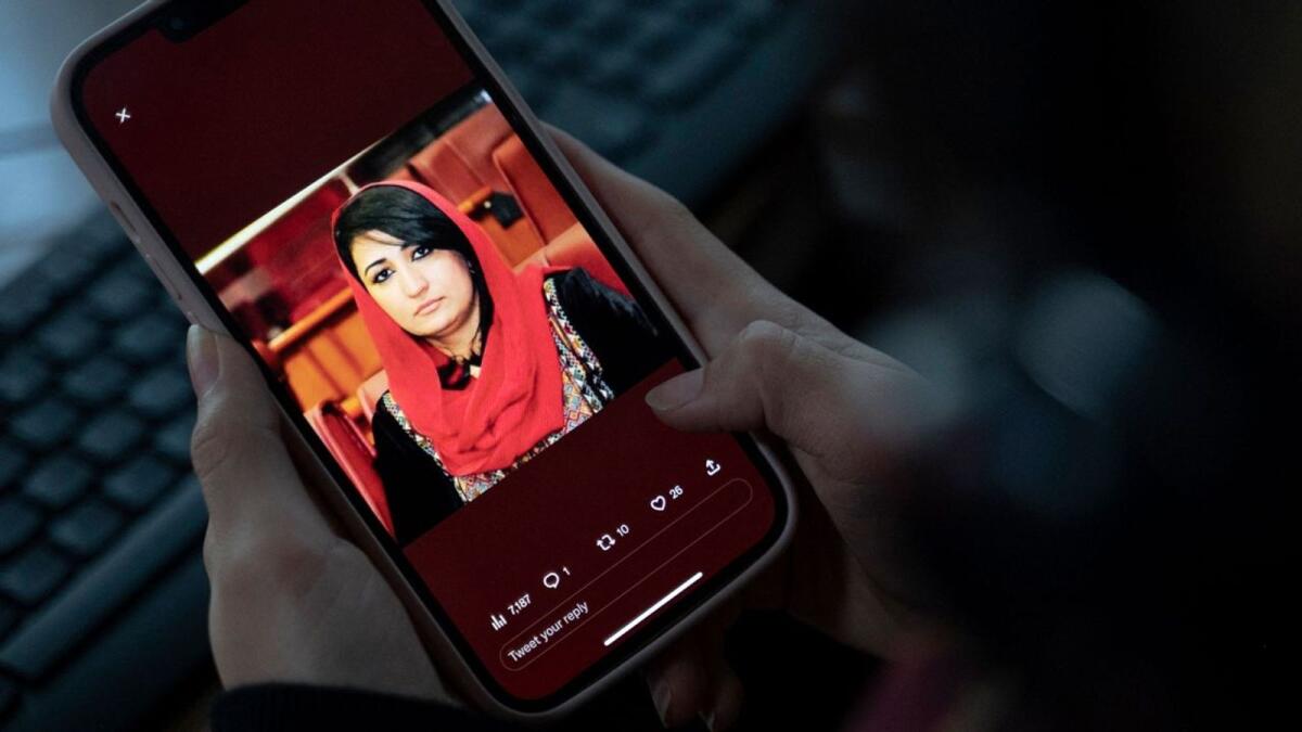 A woman looks at a picture of former Afghan lawmaker Mursal Nabizada on her mobile phone. Photo: AFP