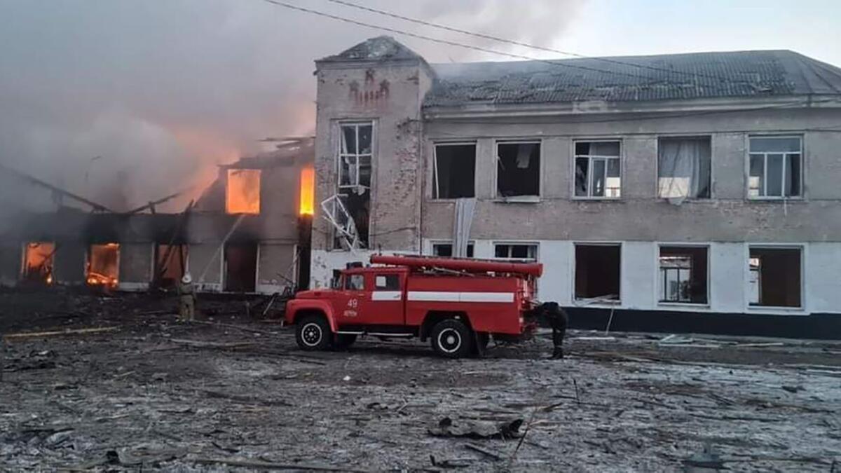 In this handout picture taken and released by the State Emergency Service of Ukraine on March 17, 2022, firemen work to extinguish a fire at an educational institution hit by shelling in the town of Merefa in the Kharkiv region. Photo: AFP