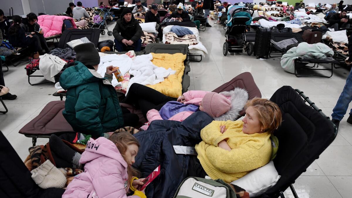People rest at a refugee reception center at the Ukrainian-Polish border crossing in Korczowa on March 5, 2022. Photo: AFP