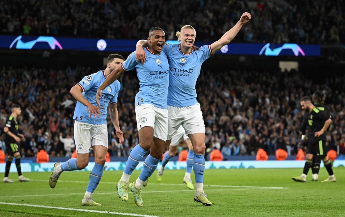Manchester City's Manuel Akanji (left) celebrates scoring the team's third goal with Erling Haaland. — AFP