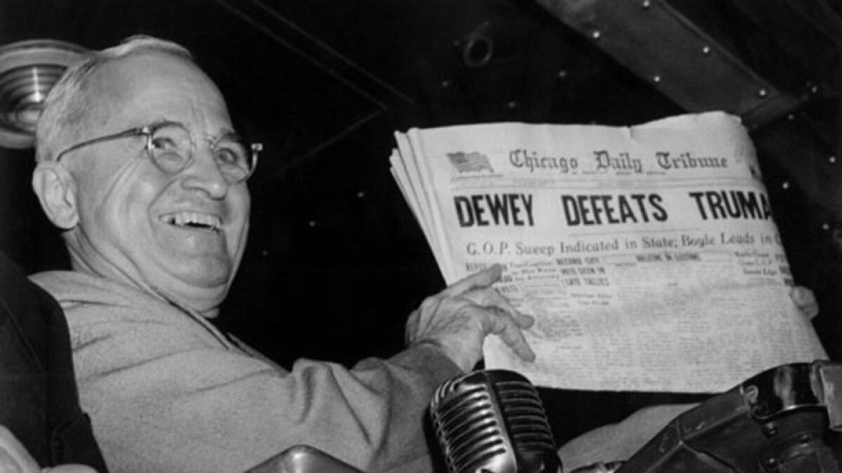 Newly elected president Harry Truman holding up the Chicago Daily Tribune paper that announced his 'defeat'