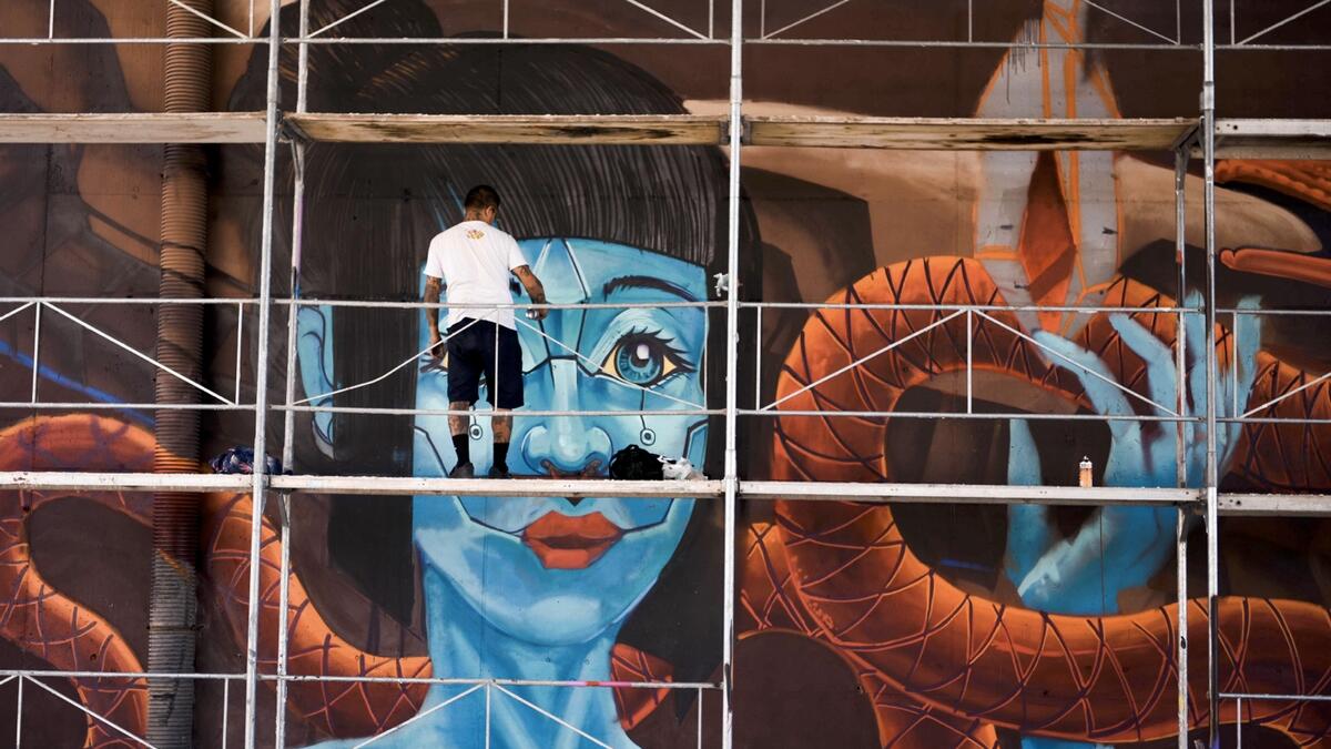 This photograph taken on September 1, 2020, shows a Mexican graffiti artist working on his piece during the graffiti festival 'Meeting Of Styles', in Pristina. The International Meeting of Styles (MOS) is an international network of graffiti artists and aficionados that began in Wiesbaden, Germany. Photo: AFP