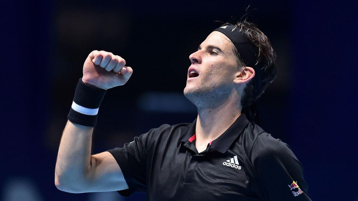 Austria's Dominic Thiem celebrates winning against Spain's Rafael Nadal in their men's singles round-robin match on day three of the ATP World Tour Finals.— AFP