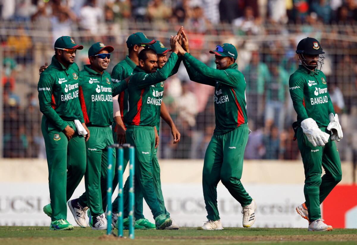 Bangladesh's Mehidy Hasan Miraz celebrates with teammates after taking the wicket of England's Moeen Ali. — Reuters