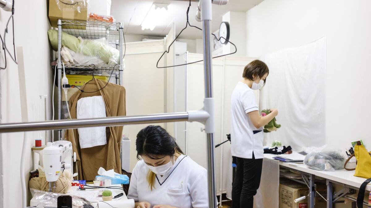 Employees working on stuffed toys at Natsumi Clinic in Tokyo.