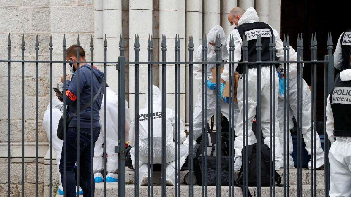 Forensic specialists inspect the scene of a reported knife attack at Notre Dame church in Nice, France, October 29, 2020.