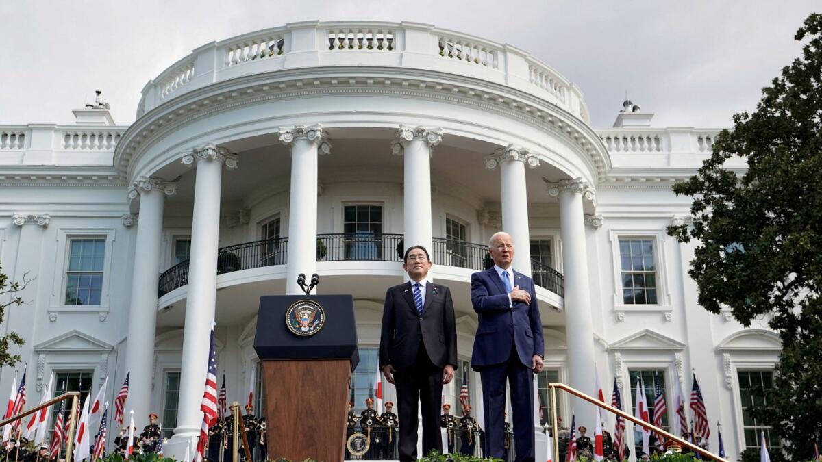 US President Joe Biden and Japanese Prime Minister Fumio Kishida stand for national anthems during a state visit at the White House in Washington on Wednesday. — Reuters
