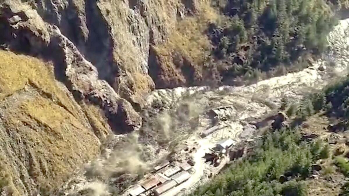 This screengrab from a video shows a massive flood of water, mud and debris flowing at Chamoli District after a portion of Nanda Devi glacier broke off in Tapovan area of Uttarakhand, India. — AP