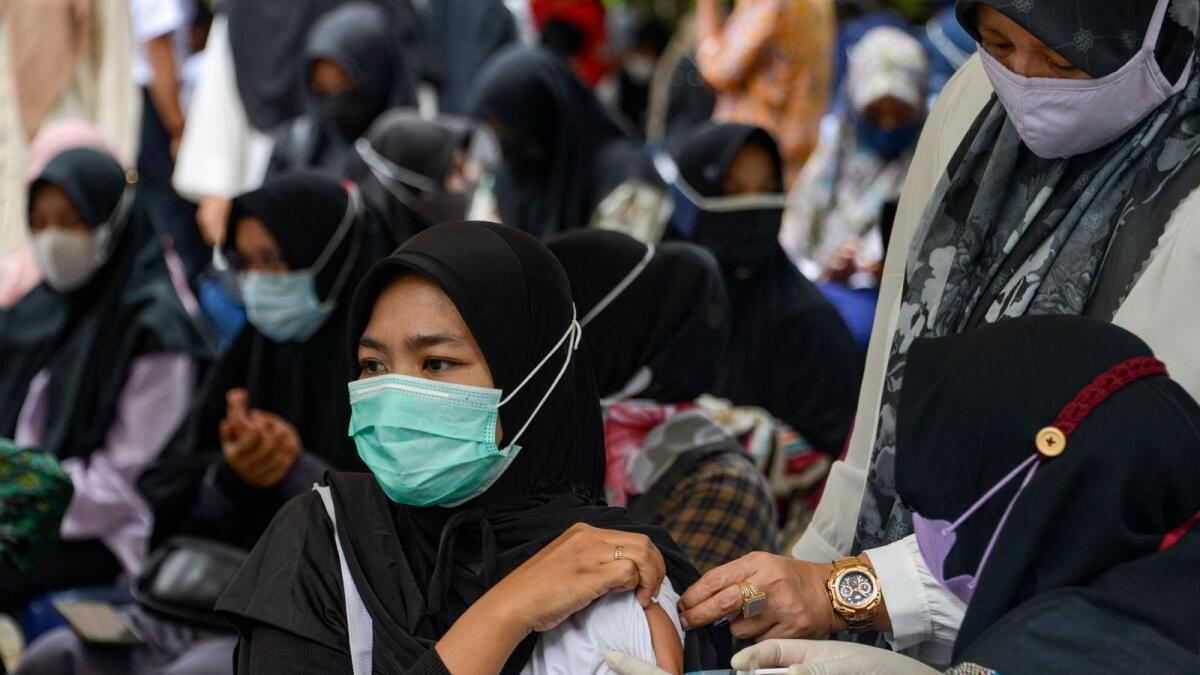 A woman receives a dose of Sinovac vaccine in Indonesia. Photo: AFP