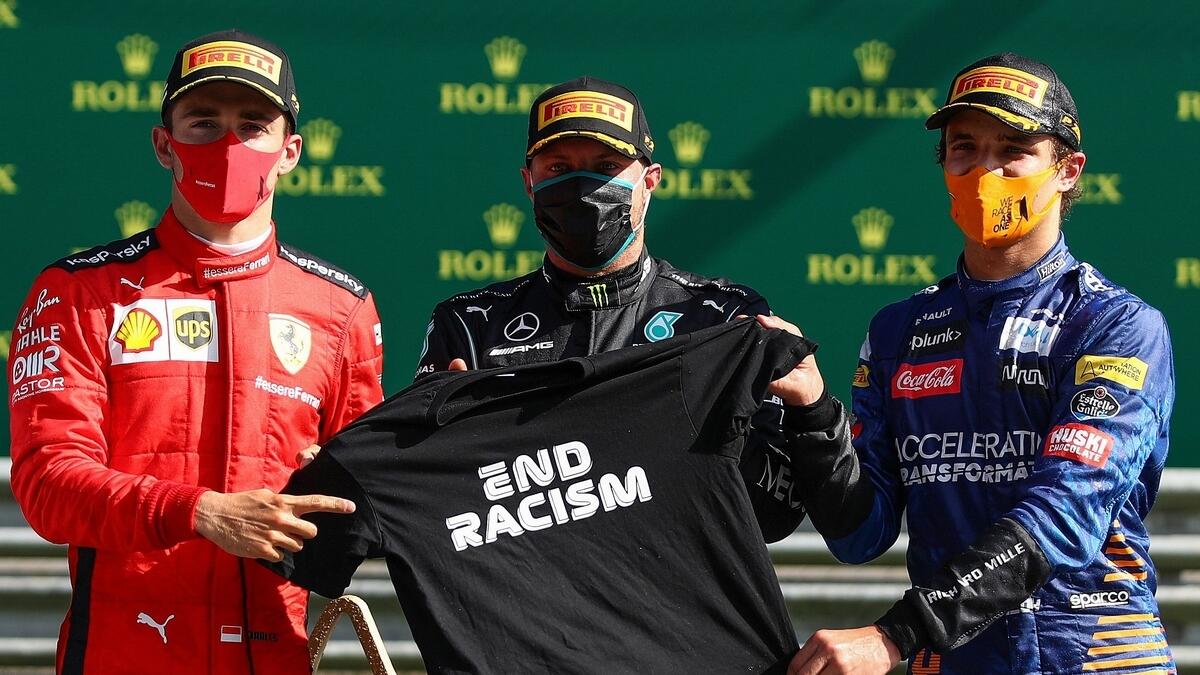 (L-R) Ferrari's Charles Leclerc, Mercedes' Valtteri Bottas and McLaren's Lando Norris pose with the 'End Racism' t-shirt on the podium after the Austrian Formula One Grand Prix race on Sunday. (AFP)