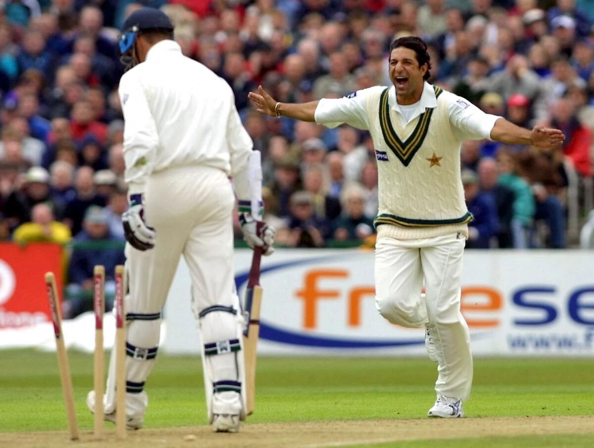 Pakistan fast bowler Wasim Akram celebrates after dismissing England batsman  Marcus Trescothick during a Test match at Manchester in 2001. — AFP