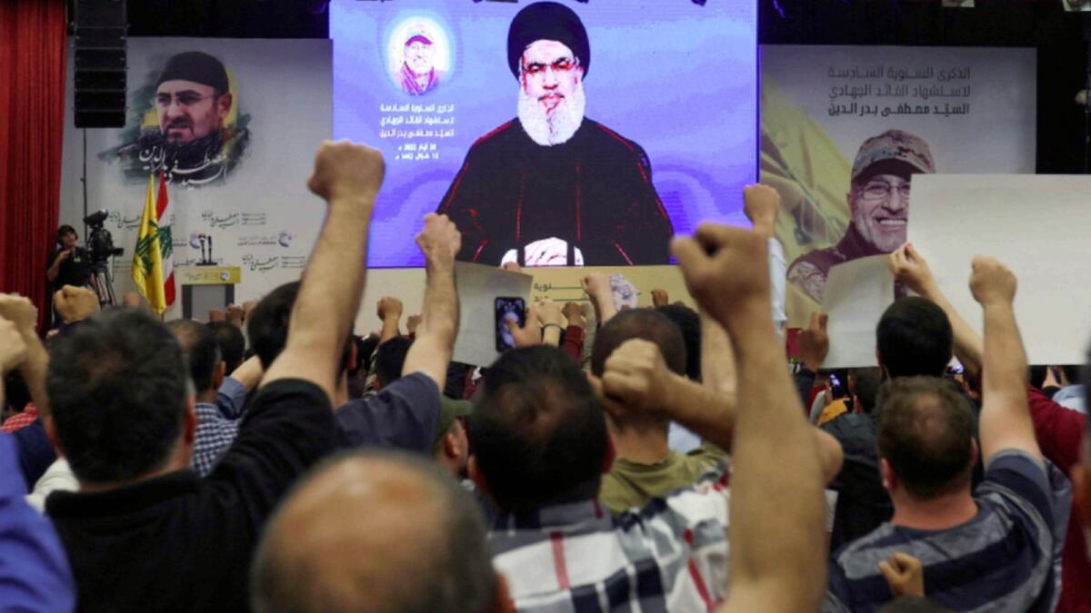 Lebanon's Hezbollah leader Sayyed Hassan Nasrallah addresses his supporters via a screen during a rally commemorating late Hezbollah commander Mustafa Badreddine who was killed in an attack in Syria. — Reuters