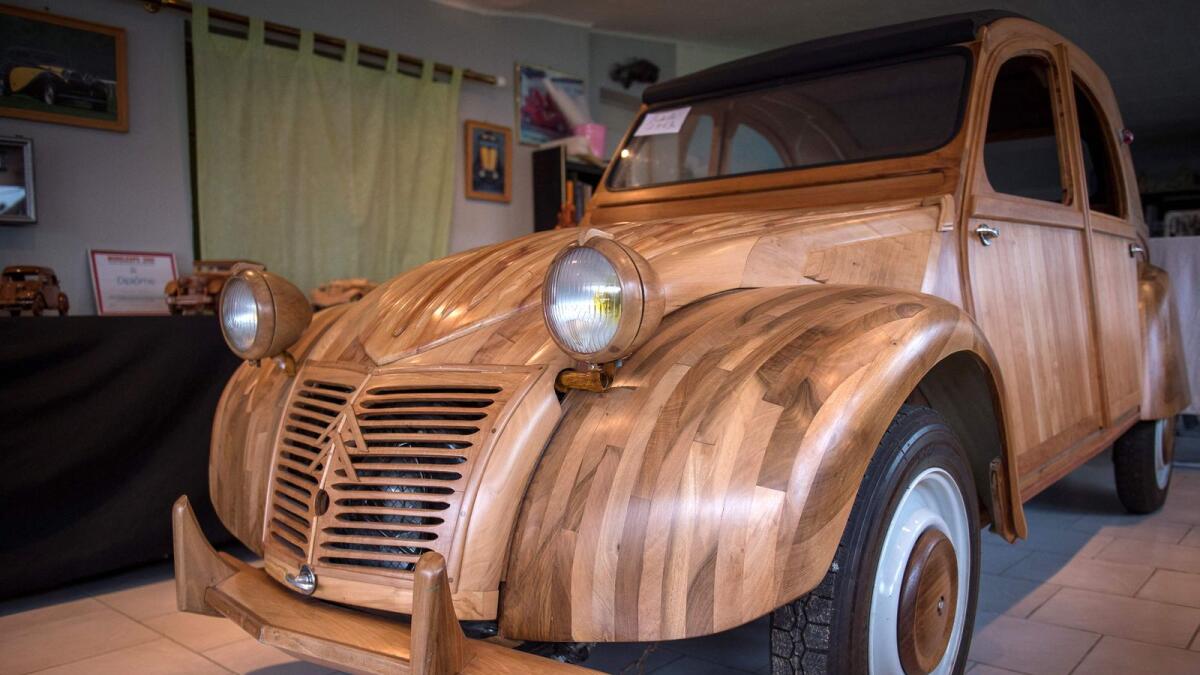 A handbuilt wooden 2CV Citroen Car. — AFP file