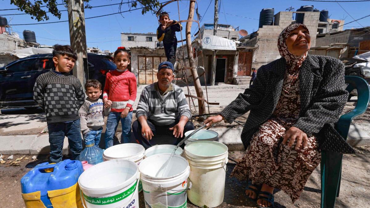 Palestinians fetch water in Rafah in the southern Gaza Strip. PHOTO: AFP