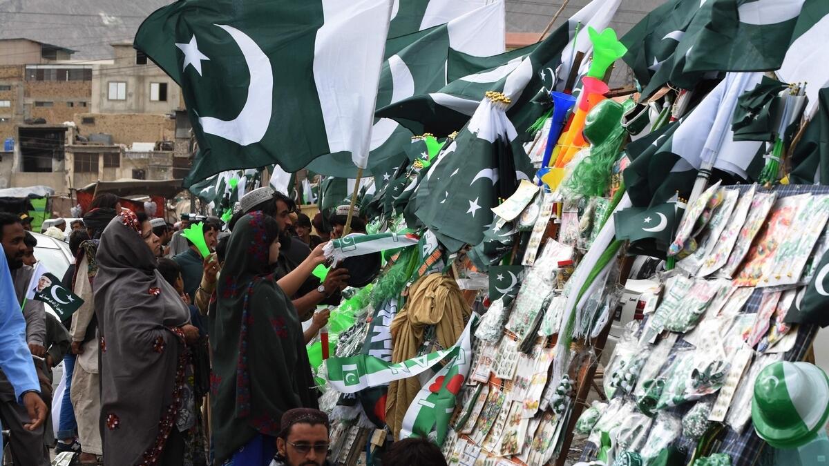 People gather around a stall selling merchandise with Pakistan's national flag in Quetta. AFP