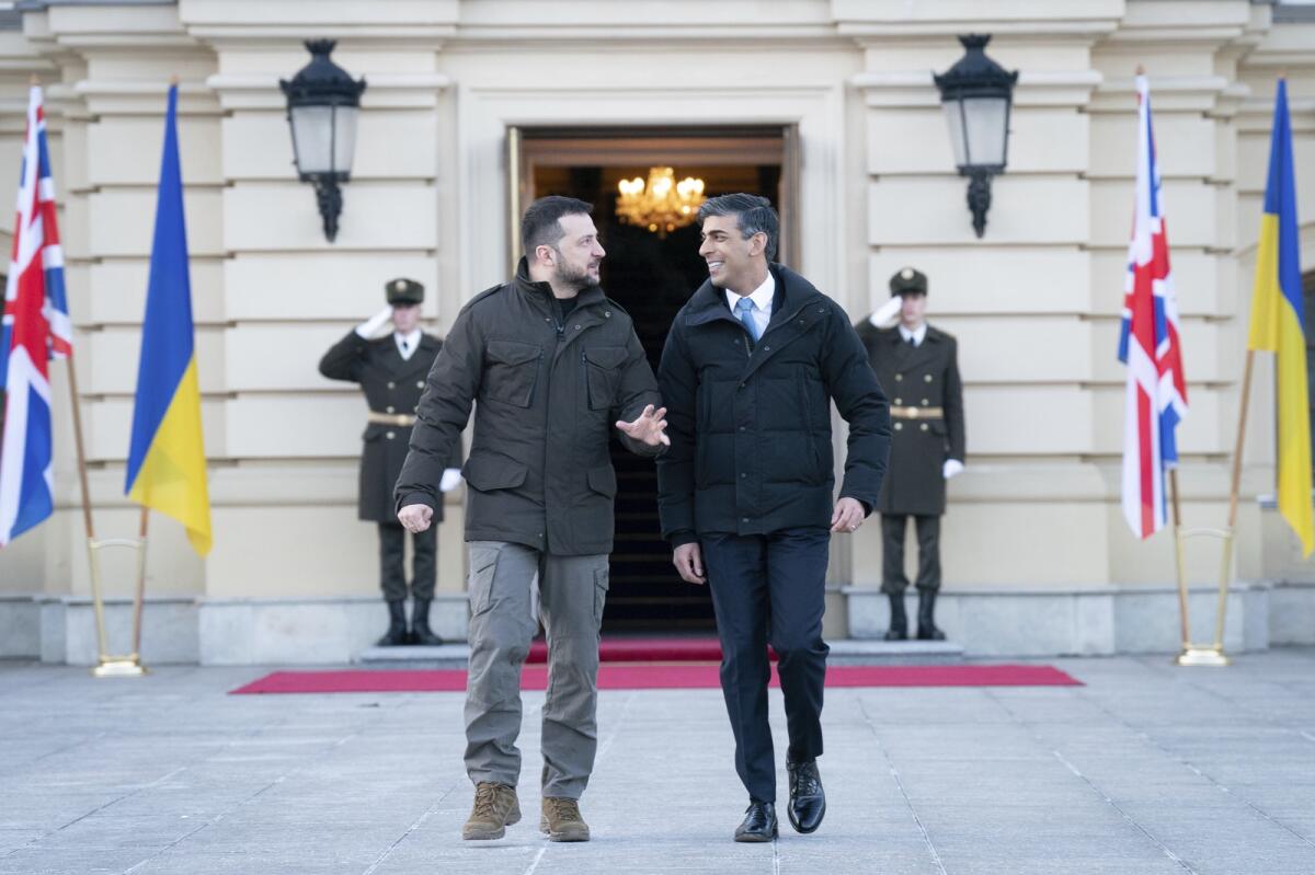 Rishi Sunak walks with Volodymyr Zelensky during a visit to the Presidential Palace in Kyiv. — AP