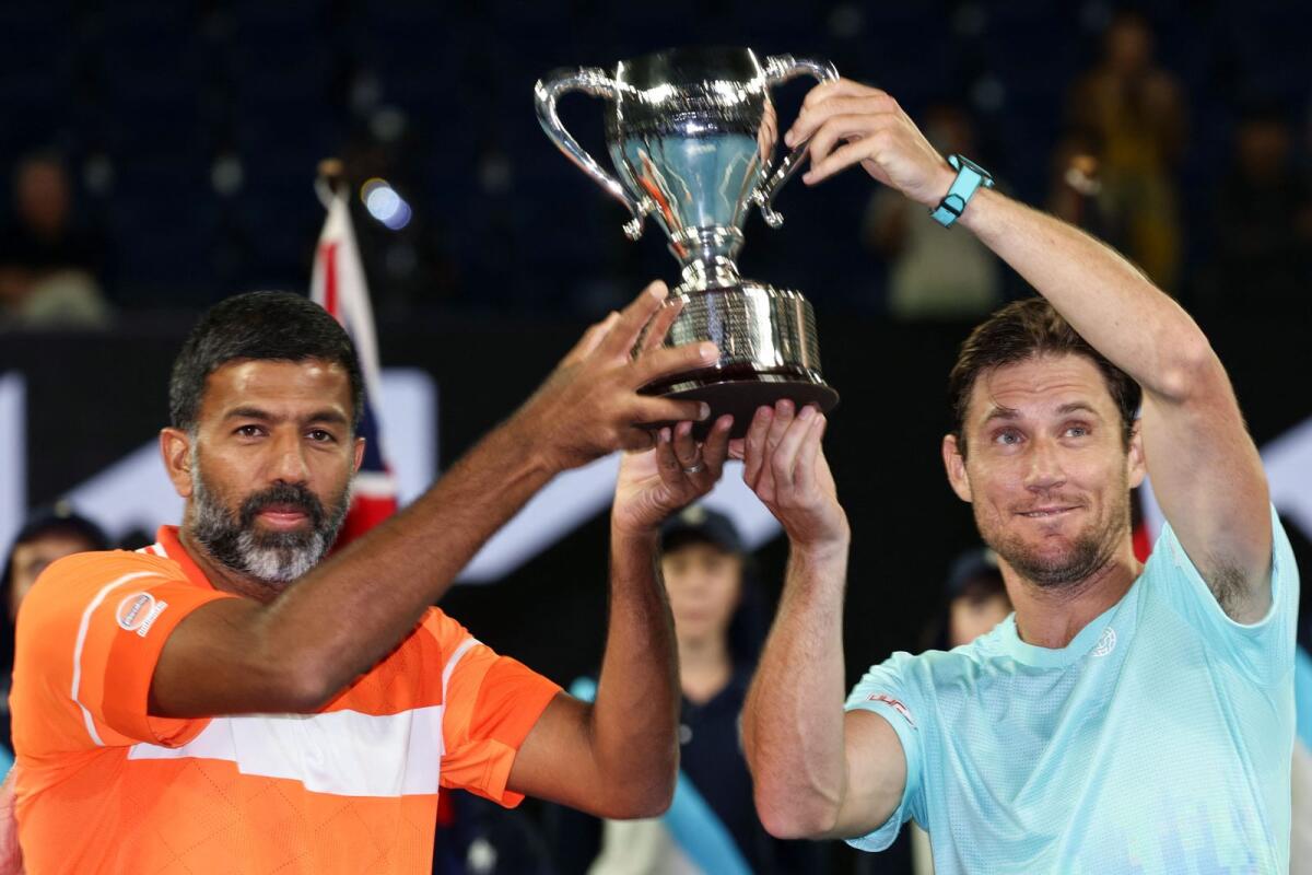 India's Rohan Bopanna (L) and Australia's Matthew Ebden celebrate with the trophy after victory against Italy's Simone Bolelli and Andrea Vavassori during their men's doubles final. - AFP